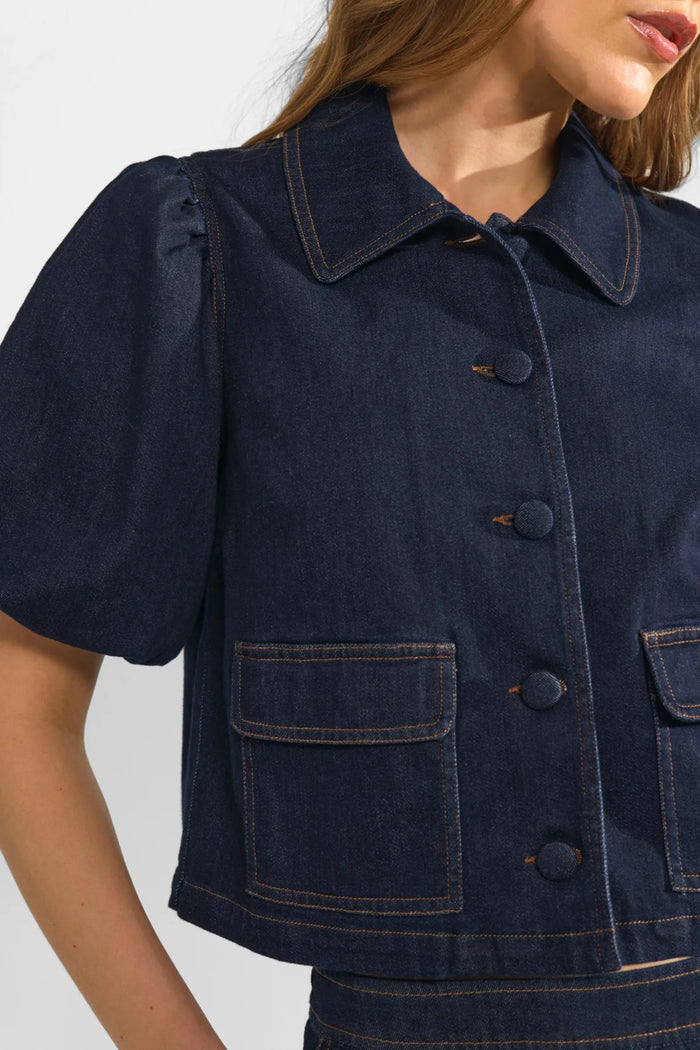 Model wearing Numph 707020 NUALETTA SS Shirt – Dark Blue Denim with puffed sleeves and front flap pockets by Numph. Shop Numph at Dotique.