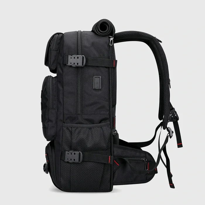 Side view of black nylon travel backpack with USB charging port and compression straps