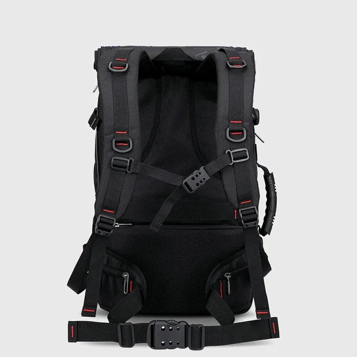 Back view of black travel backpack with padded shoulder straps, chest strap and waist belt