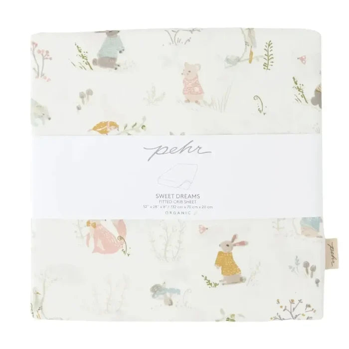 A folded baby blanket with a whimsical woodland animal print on a cream background, wrapped in a white paper band labeled 'peoh' and 'Sweet Dreams'.