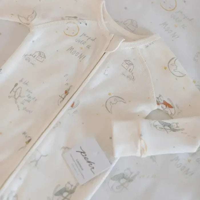 Baby outfit with illustrations and text on a light background