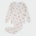 A two-piece children's pajama set by Fabris, featuring a long-sleeve top and matching pants in a warm cream color with an all-over print of orange foxes, brown rabbits, and gray squirrels. The brand label 'FABRIS' is visible on the inner neck tag.