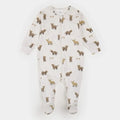 A baby footed zip-up sleeper in off-white with an all-over print of brown and tan woodland animals, photographed flat on a light gray background.