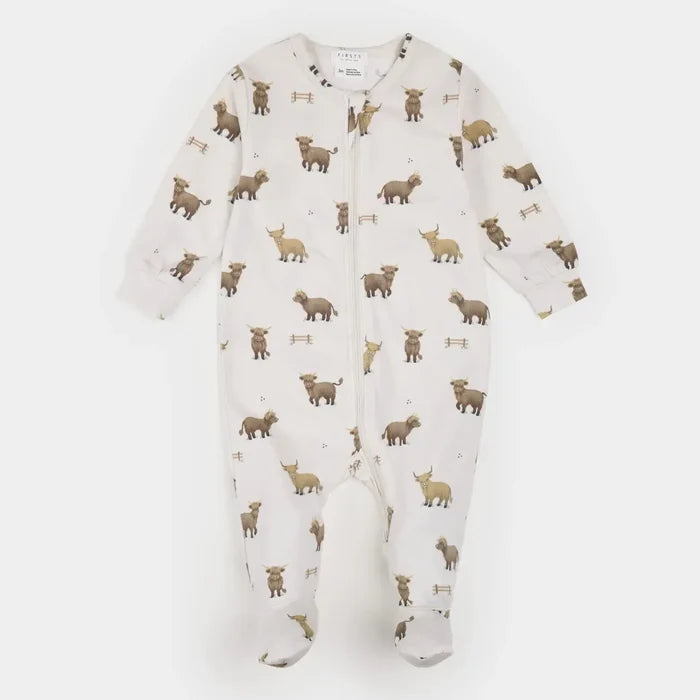 A baby footed zip-up sleeper in off-white with an all-over print of brown and tan woodland animals, photographed flat on a light gray background.