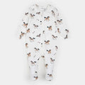 A white long-sleeve footed sleeper with an all-over print of brown, black, and white horses, shown flat on a light gray background.