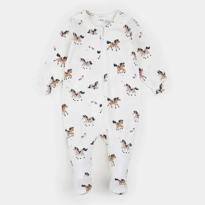 A white long-sleeve footed sleeper with an all-over print of brown, black, and white horses, shown flat on a light gray background.