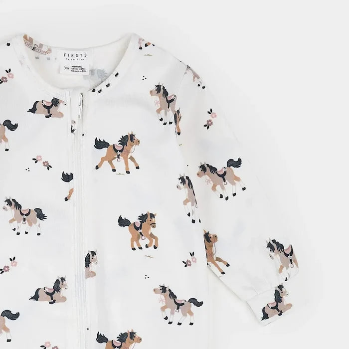 A white long-sleeve zip-up baby romper with an all-over print of cartoon horses in tan, brown, and black, shown on a clean white background.