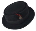 A black flat top Pork Pie fedora hats with a patterned band and a red feather decoration on the side.