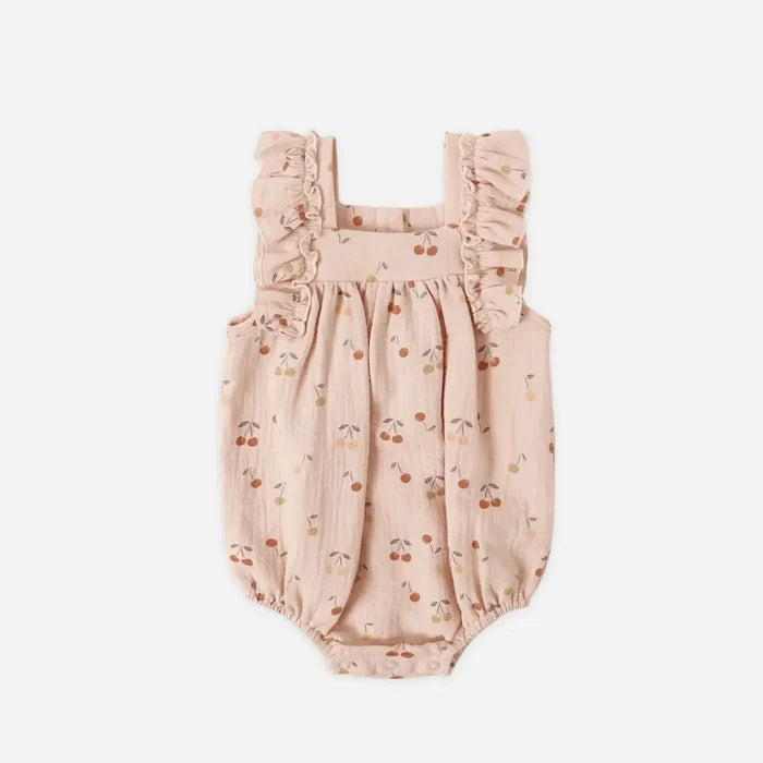 Baby romper with cherry pattern on a white background