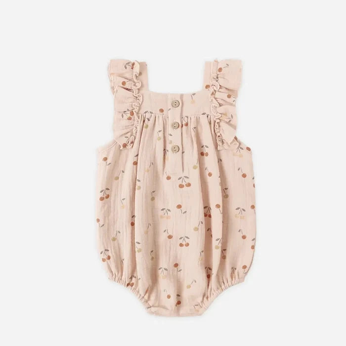 Baby romper with cherry pattern on a white background
