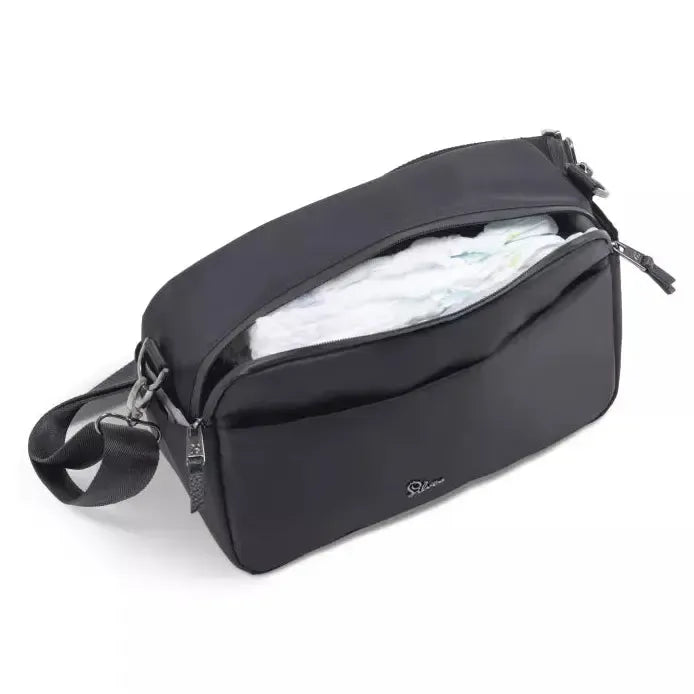 Black diaper bag with a white diaper inside on a white background