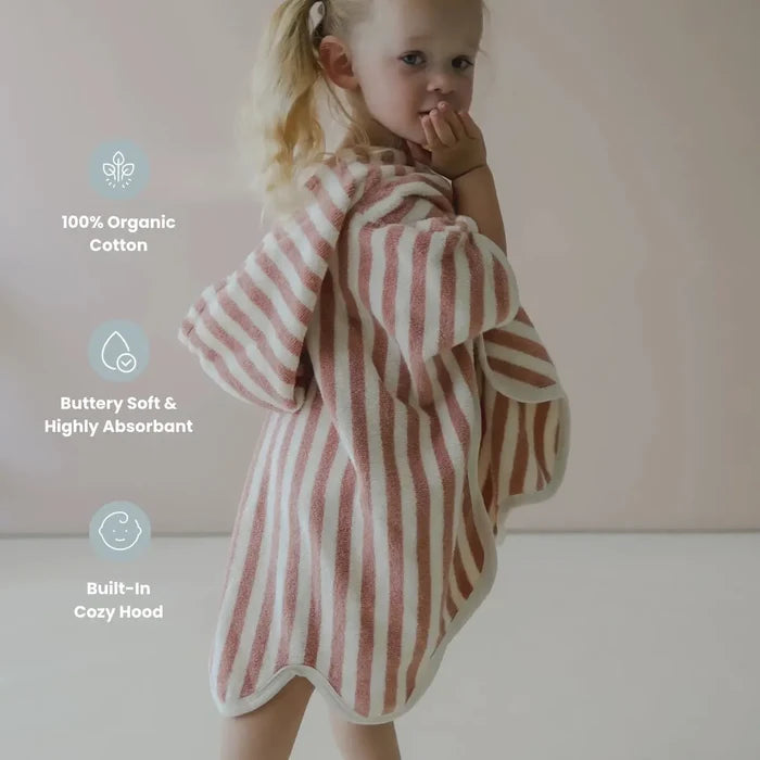 Child wearing a striped towel with product features highlighted on a plain background