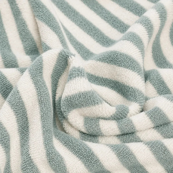 Close-up of a textured fabric with green and white stripes