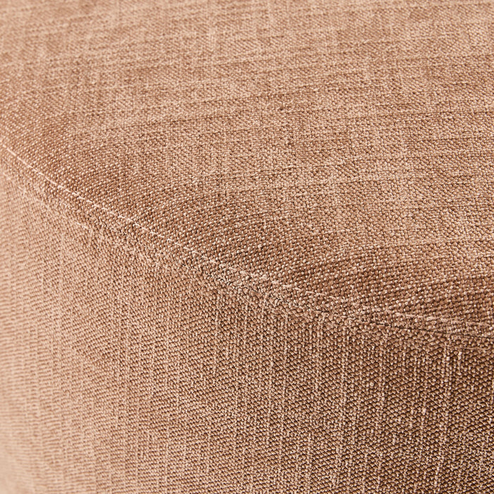 Close-up of a polyester weave fabric covering the curved surface of a Tango Round Ottoman Large Solace Dusty Pink, showcasing its elegant texture.