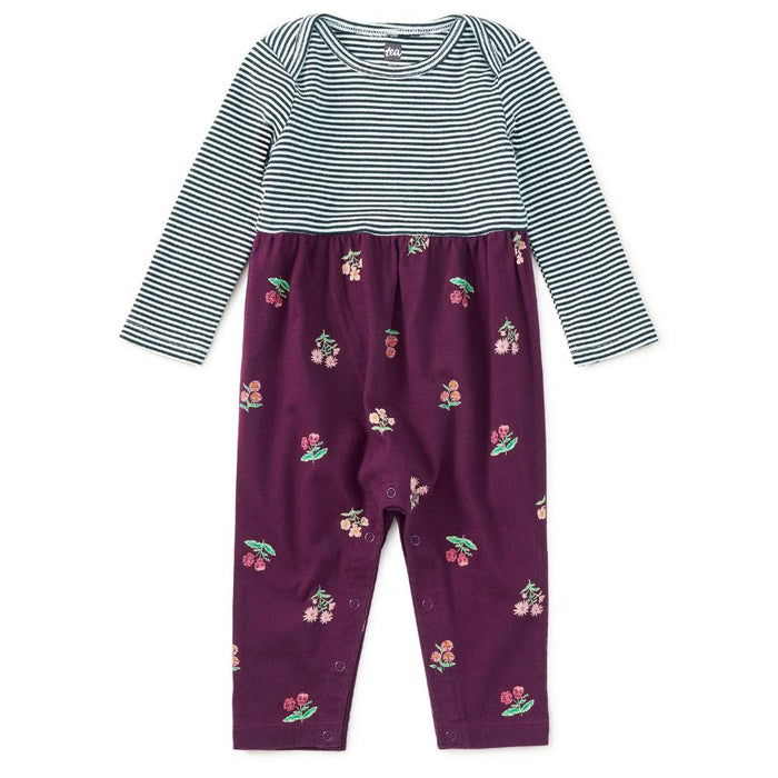 A baby long-sleeve romper with a navy and white striped top half and purple pants with a cherry print, shown flat on a white background.