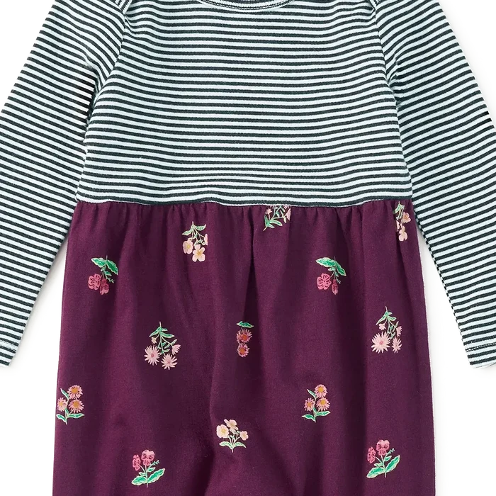 A baby long-sleeve romper with a navy and white striped top and dark purple pants featuring a cherry print, shown flat on a white background.