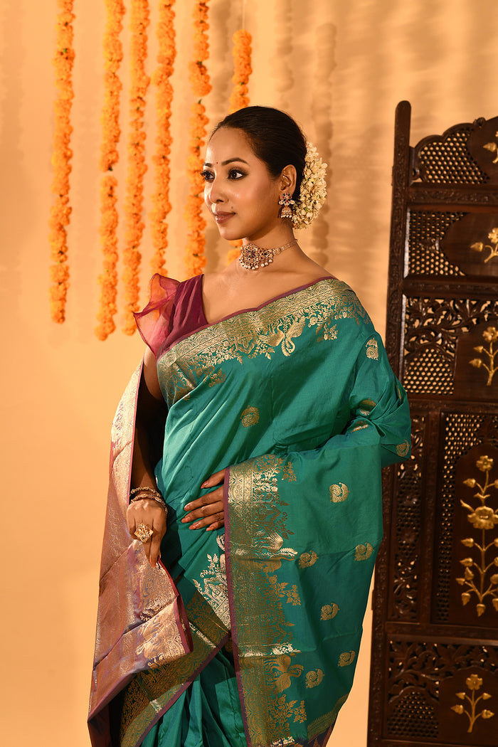 Teal Green With Gold Zari Butti And Bronze Woven Pallu Kanjivaram Silk Saree