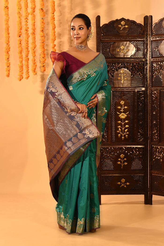 Teal Green With Gold Zari Butti And Bronze Woven Pallu Kanjivaram Silk Saree
