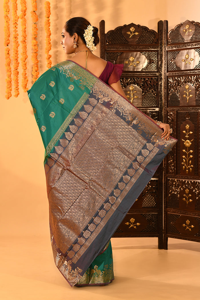 Teal Green With Gold Zari Butti And Bronze Woven Pallu Kanjivaram Silk Saree