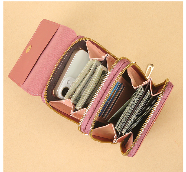 Large-capacity interior of a touchscreen crossbody phone bag holding a phone, cards and cash with room for everyday essentials