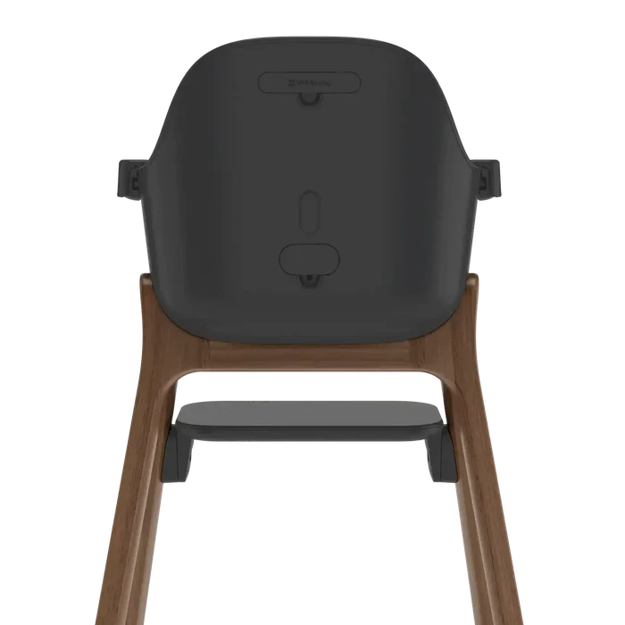 Rear view of a high chair with a dark gray molded seat and a natural wood frame, shown on a solid white background.