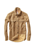 A tan long-sleeve button-up shirt with two buttoned chest pockets, shown flat against a solid white background.