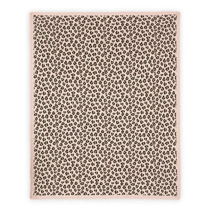 A rectangular area rug with a dense leopard print pattern in brown and black on a dusty pink background, finished with a solid dusty pink border.