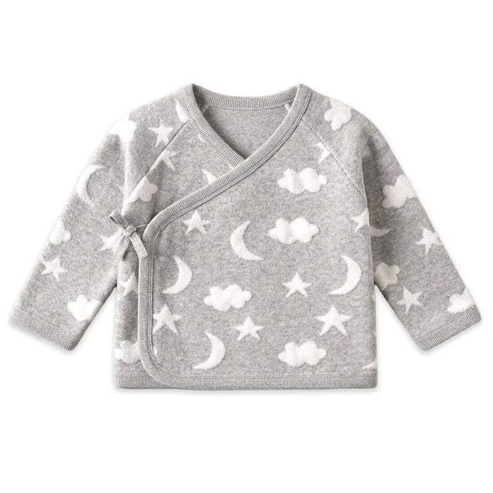 A baby long-sleeve wrap top in heather gray with a white cloud, moon, and star pattern, featuring a wrap-style collar and tie closure on the front.