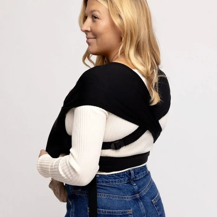 Woman showing back of black baby wrap carrier