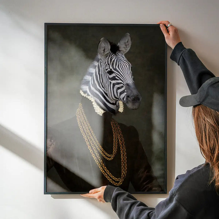 Zebra Portrait Print being hung on a wall in a black frame